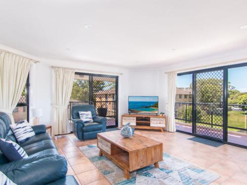 a living room with a couch and a coffee table at Horizons 8 on the lake in Forster
