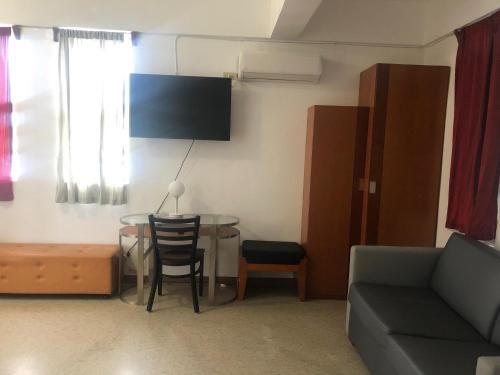 a living room with a couch and a table at Coral Garden Hotel in Rota