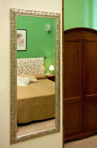 a mirror reflection of a bed in a bedroom at B&B Dimora San Vincenzo in Gallipoli