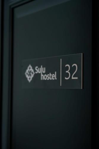 a sign on a door that reads sun hospital at Sulu Hostel in Astana