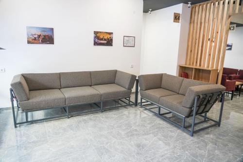 a waiting room with two couches in a room at Sulu Hostel in Astana