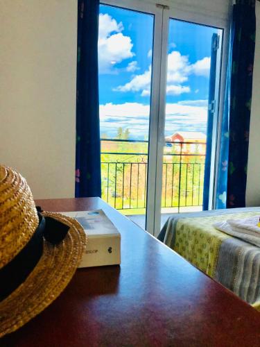 a room with a table with a book and a window at Banos Apartment with 2 rooms and swimming pool in Roda