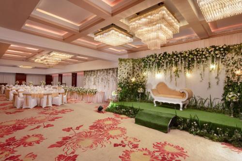 a banquet hall with tables and a couch in a room at Earl's Regency Hotel in Kandy