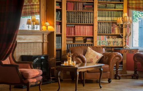 a living room with a couch and a table and books at Dingle Benners Hotel in Dingle