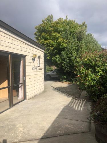 a garage with a car parked next to a building at Solway House in Alexandra