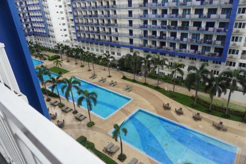 a view of the pool from the balcony of a building at Premiere Haven MOA Staycation in Manila