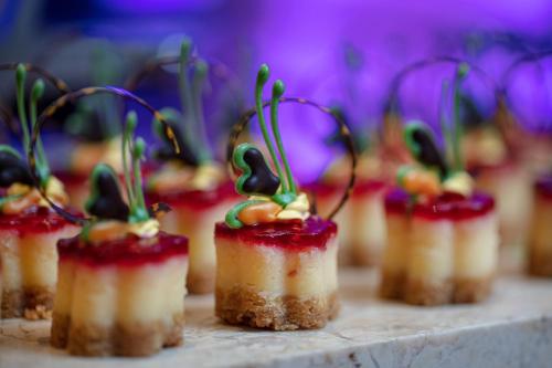 a row of mini desserts on a table at Earl's Regency Hotel in Kandy