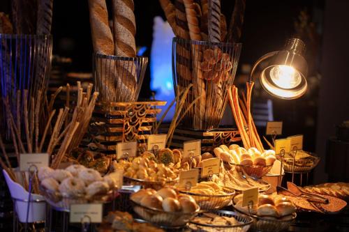 a display of bread and pastries on a table at Earl's Regency Hotel in Kandy