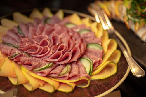 a plate of food with meat and vegetables on a table at Earl's Regency Hotel in Kandy