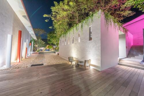 a hallway with two chairs and a building with lights at Sai Kaew Beach Resort in Ko Samed
