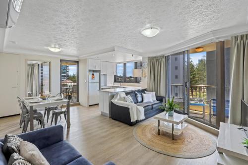 a living room with a couch and a table at Boulevard North Holiday Apartments in Gold Coast