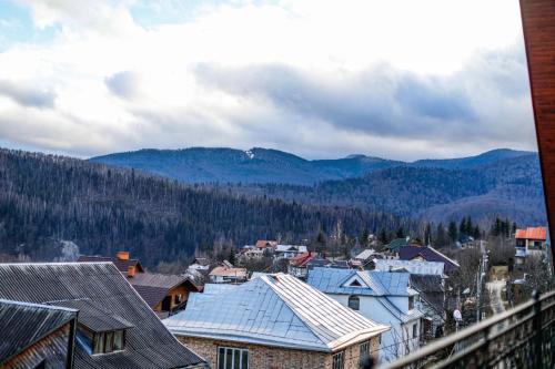 a view of a city with mountains in the background at Карпатська Вершина in Yaremche