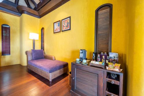 a living room with a chair and a table at Paradee in Ko Samed