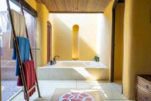 a bathroom with a tub and a sink at Paradee in Ko Samed