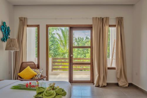 a bedroom with a bed and a sliding glass door at Shaviyani Retreat in Ukulhas