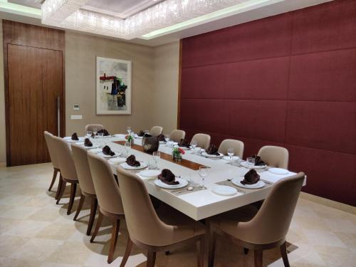 a conference room with a long table and chairs at The Imperial Palace in Rajkot
