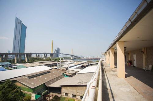 a view of a building with a bridge in the background at The View Residence in Bangkok