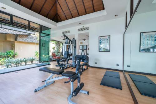 an indoor gym with exercise equipment in a house at Paradee in Ko Samed