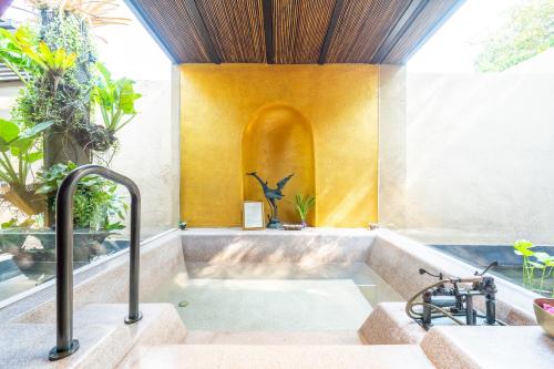 a bath tub in a room with a sink at Paradee in Ko Samed