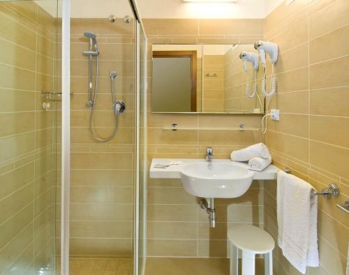 a bathroom with a sink and a shower at Hotel Tura in Bellaria-Igea Marina