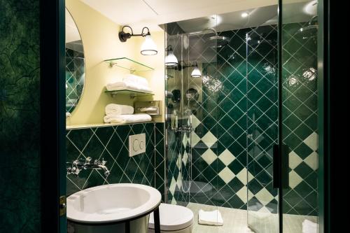 a bathroom with a sink and a shower at Bonsoir Madame in Paris