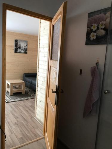 an open door to a living room with a couch at Casute la munte in Râşnov