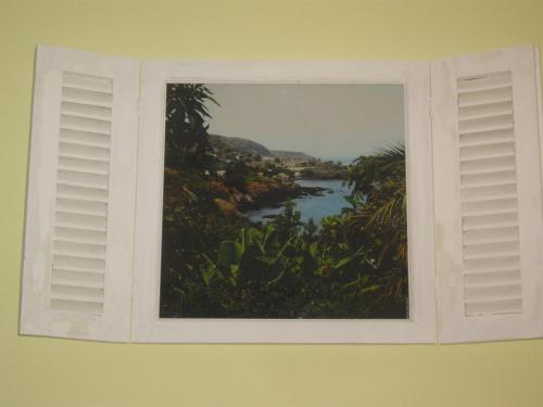 a window with a picture of a river at Kira's Boutique Hotel in Mindelo