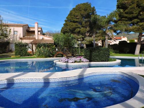 a swimming pool in front of a house at Doree 449 in Bonmont Terres Noves