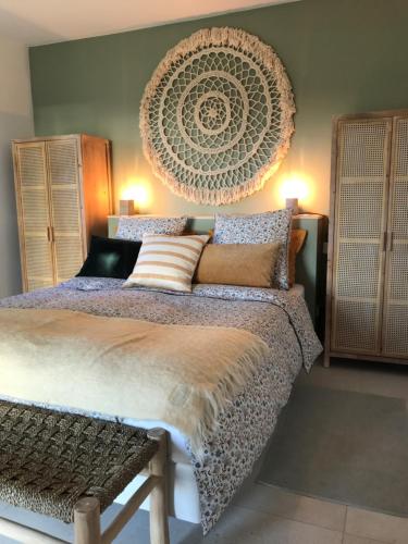 a bedroom with a large bed with a large headboard at Maison Chaban Sanary sur mer in Sanary-sur-Mer