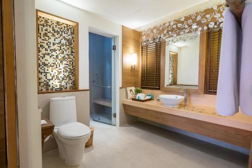 a bathroom with a toilet and a sink and a mirror at Ao Prao Resort in Ko Samed