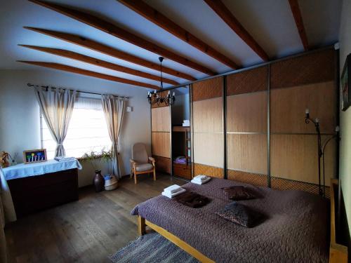 a bedroom with a large bed in a room at Jaunstūrīši in Ādaži