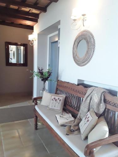 a living room with a bench and a mirror at Hotel Azalea Playa in Chiclana de la Frontera