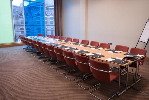 a conference room with a long table and chairs at Leonardo Hotel Aberdeen in Aberdeen