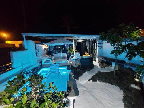 a blue house with a swimming pool at night at ALOELUX VILLA ! - Private Villa with Jacuzzi, cinema ,massage ,wonderful view, art desing villa in Conil