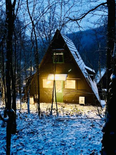 a house with a light on the front in the snow at Chalet Durbuy 123 in Durbuy