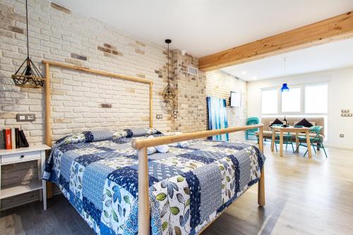 a bedroom with a bed and a brick wall at Chic y sofisticado Loft en la playa in Valencia