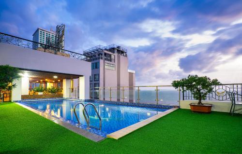a swimming pool on the balcony of a building at Apus Hotel in Nha Trang