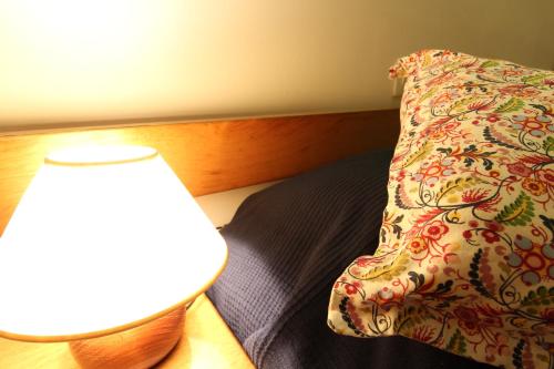 a bedroom with a bed with a pillow and a lamp at Apartaments El Sorrall in Blanes