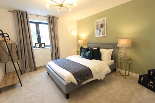 a bedroom with a bed with pillows and a window at Cabot Mews Apartment 2 in Bristol