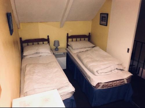 two twin beds in a small room with at Cottage in village of Mevagissey Cornwall Sleeps 4 in Mevagissey