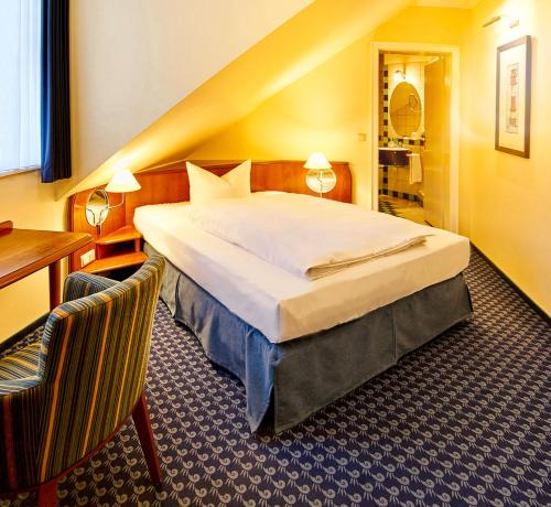 Säng eller sängar i ett rum på Neptun Hotel Kühlungsborn