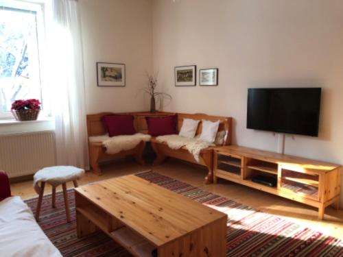 a living room with a couch and a television at Apartmán Velké Karlovice in Velké Karlovice