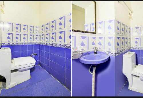 a blue and white bathroom with a toilet and a sink at Hotel kingsman in Rudrapur