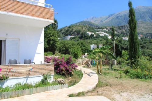a house with a garden and a walkway at PENELOPE 2 in Dhërmi
