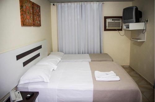 Ένα ή περισσότερα κρεβάτια σε δωμάτιο στο Hotel Nosso Bosque