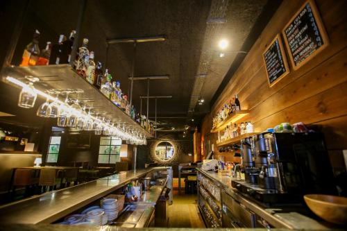 a bar in a restaurant with a long counter at Gatell Hotel in Vilanova i la Geltrú