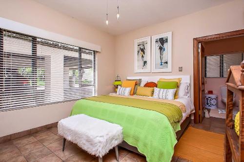 a bedroom with a large bed and a window at Vaal River YOLO Spaces - Vaal River Bush Villa in Sasolburg