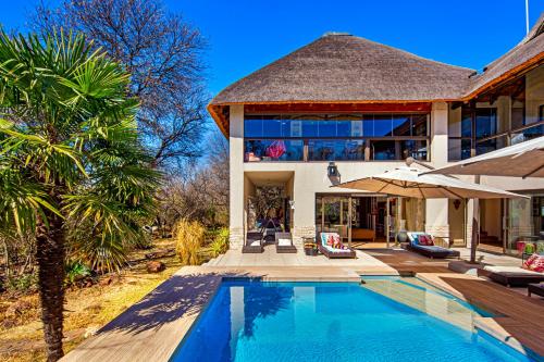 an exterior view of a house with a swimming pool at Vaal River YOLO Spaces - Vaal River Bush Lodge in Sasolburg