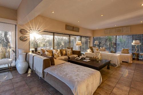 a large living room with a couch and a table at Vaal River YOLO Spaces - Vaal River Bush Lodge in Sasolburg