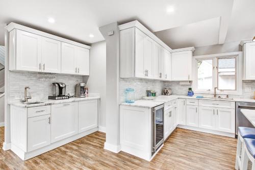 a white kitchen with white cabinets and wooden floors at Seabrook Island Geataway in Seabrook Island